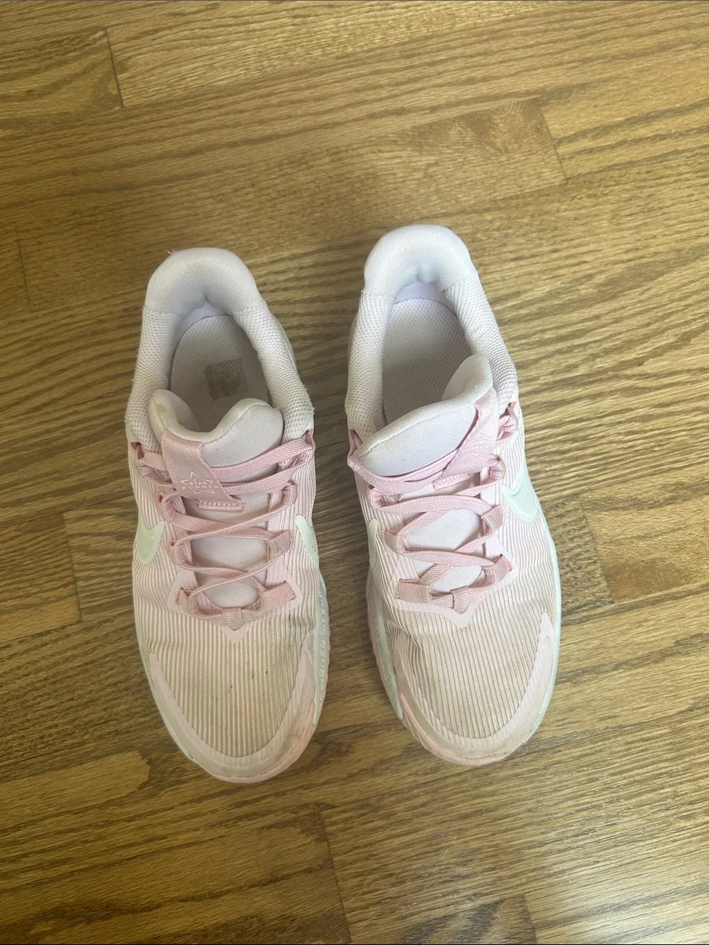 Kids Light Pink Nike Athletic Sneakers with White Swoosh